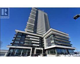 A tall, modern building with a curved design and multiple windows.