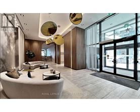 A modern interior space with a curved white couch and a glass door.