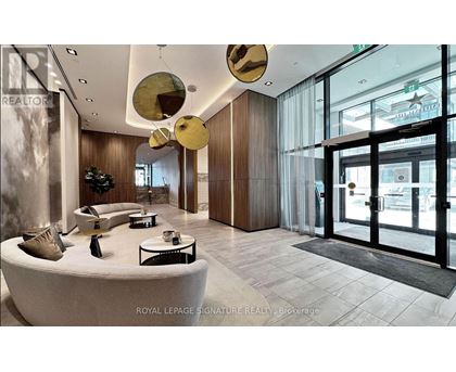 A modern interior space with a curved white couch and a glass door.