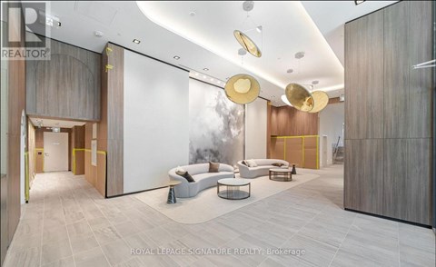 A modern living room with a white sofa set and a grey floor.