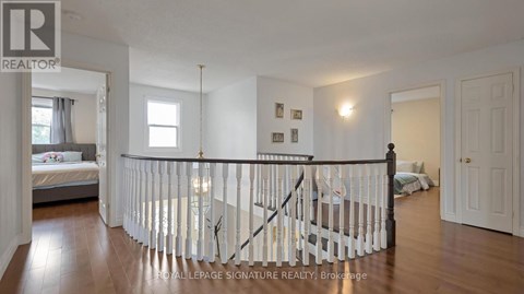 A bedroom with a white bed and a white railing.