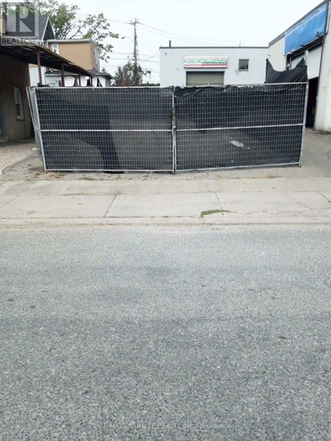 A black fence is blocking the entrance to a building.