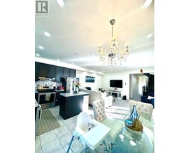 A well-lit kitchen with a dining table and chairs.
