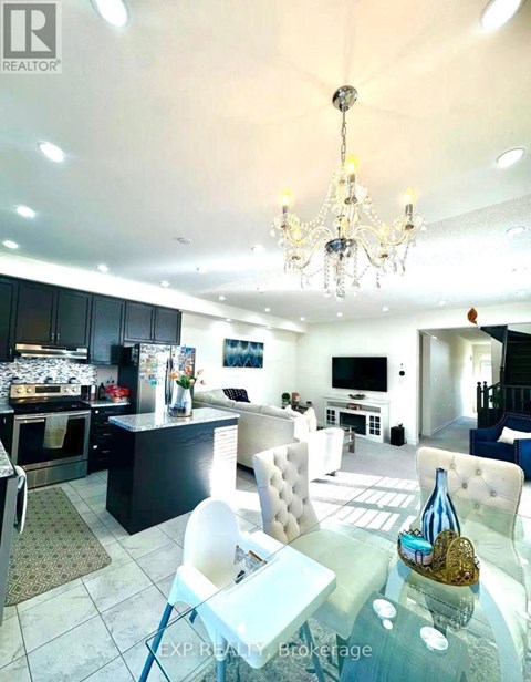A well-lit kitchen with a dining table and chairs.