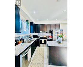 A kitchen with black cabinets and a patterned tile floor.