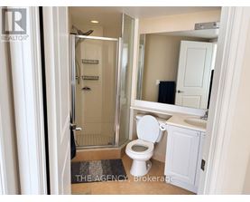 A bathroom with a toilet, sink, and shower.