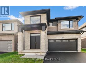 A modern house with a black garage door is for sale.