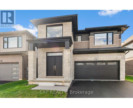 A modern house with a black garage door is for sale.