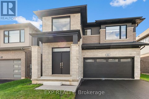 A modern house with a black garage door is for sale.