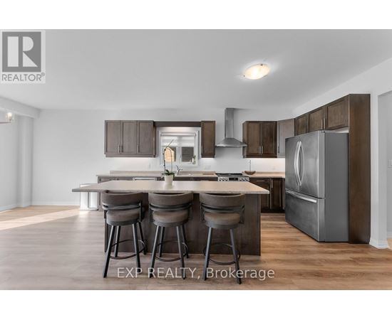 A modern kitchen with a dining table and chairs.