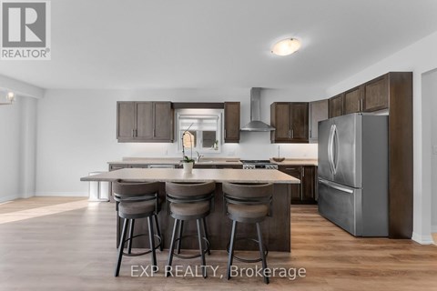 A modern kitchen with a dining table and chairs.