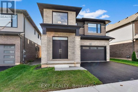 A modern house with a garage is for sale.