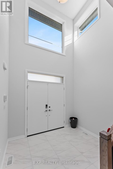 A white room with a door and a window.