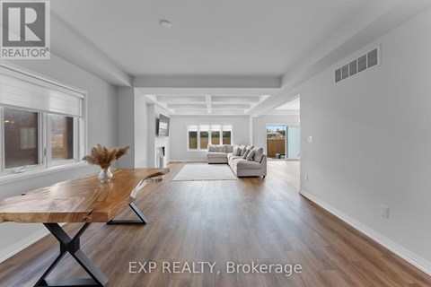 A spacious living room with a wooden table and white sofas.