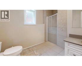 A bathroom with a toilet, sink, and shower.