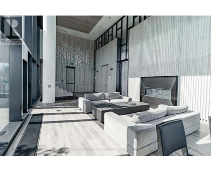 A modern living room with a large couch and a television.