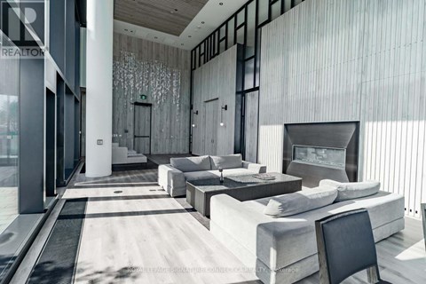 A modern living room with a large couch and a television.