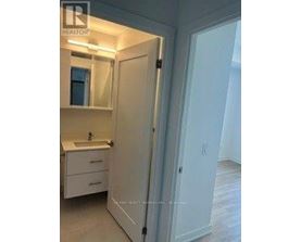 A white bathroom with a sink and mirror.