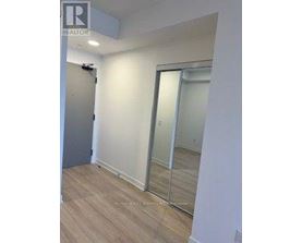 A room with a sliding door and wooden flooring.