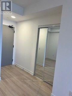 A room with a sliding door and wooden flooring.
