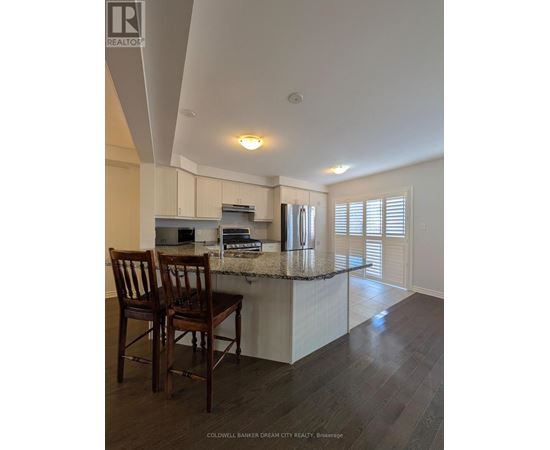 Two wooden chairs are placed on a kitchen island.