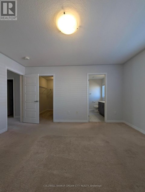 A bedroom with a bed and a dresser in the corner.