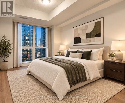 A well-lit bedroom with a large bed and a city view through the window.