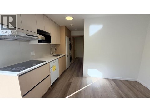 A kitchen with a stove top oven and a microwave.