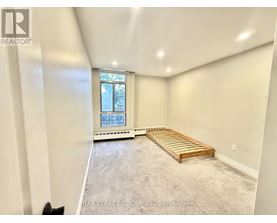 A bedroom with a bed and a window.