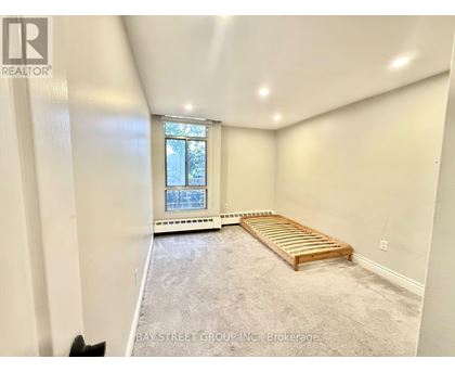 A bedroom with a bed and a window.