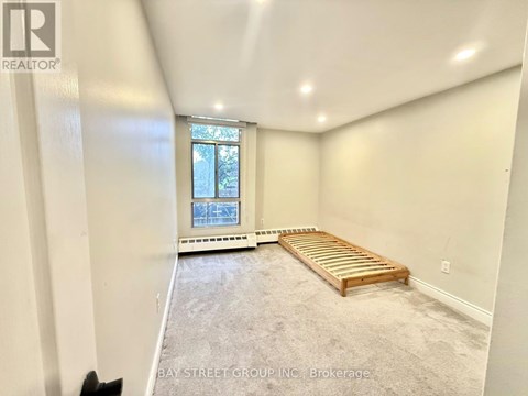 A bedroom with a bed and a window.