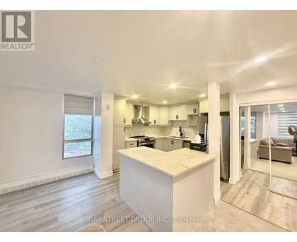 A well-lit kitchen with a large island in the middle.