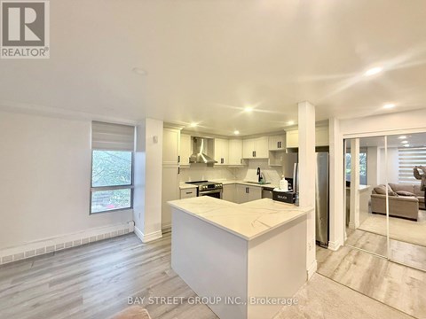 A well-lit kitchen with a large island in the middle.