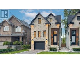 A modern house with a large front yard and a garage.