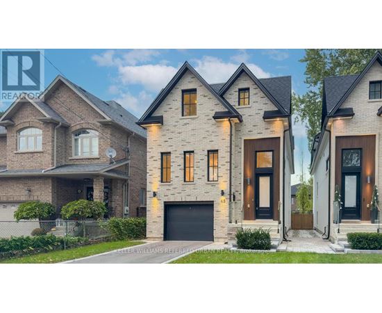 A modern house with a large front yard and a garage.