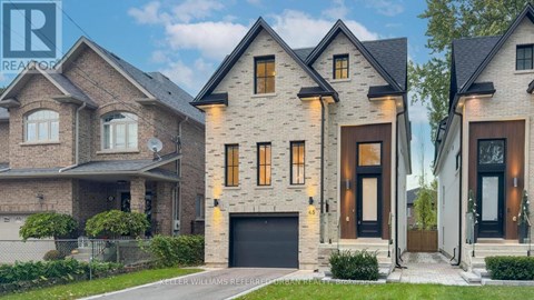 A modern house with a large front yard and a garage.