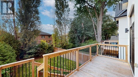 A deck with a railing and a view of a backyard with a pool.