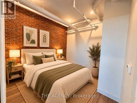 A bedroom with a brick wall and a bed with a green throw.