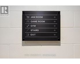 A sign with directions to the Jam Room, Game Room, Gym, Stairs and Exit.