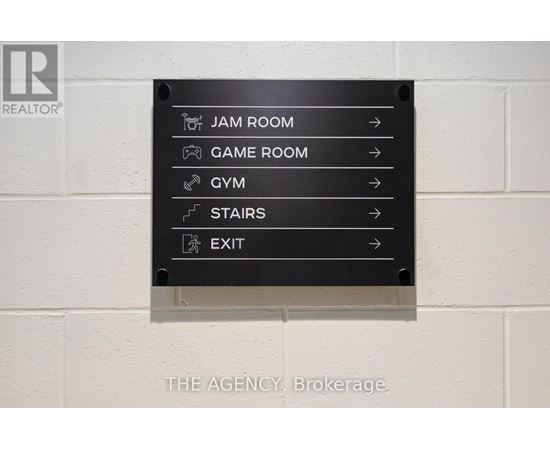 A sign with directions to the Jam Room, Game Room, Gym, Stairs and Exit.