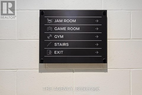 A sign with directions to the Jam Room, Game Room, Gym, Stairs and Exit.