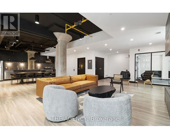 A modern living room with a large sectional sofa and a black coffee table.