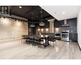 A modern kitchen with a dining table and chairs.