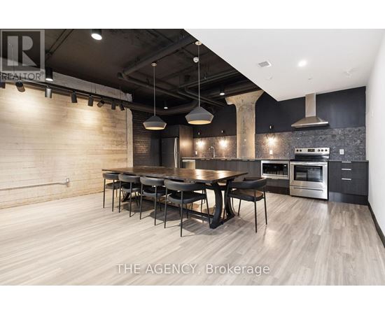 A modern kitchen with a dining table and chairs.