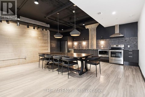 A modern kitchen with a dining table and chairs.
