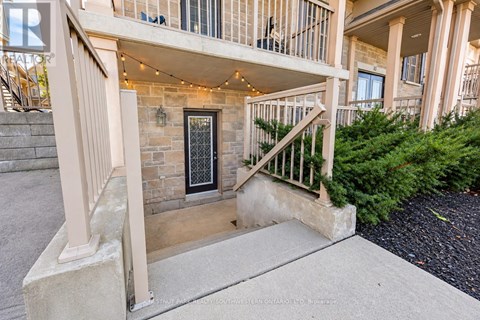 A building with a stone wall and a black door.