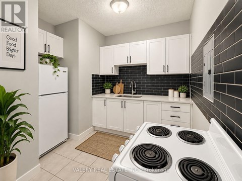 A kitchen with a table and chairs in it.