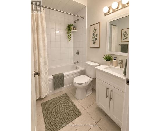 A bathroom with a toilet, sink, and shower.