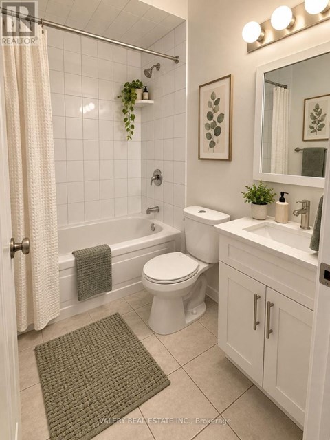 A bathroom with a toilet, sink, and shower.