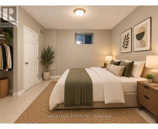A bedroom with a bed, nightstand, and a window.